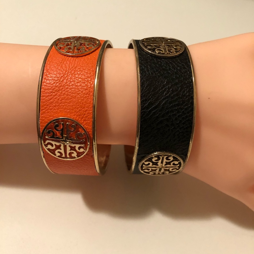 Two thick leather and metal bangle with gold logo